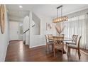 Dining area features a round wooden table, chandelier lighting, and plenty of natural light at 18079 E 108Th Pl, Commerce City, CO 80022