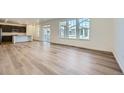 Bright living room with hardwood floors and large windows offering plenty of natural light at 4619 Windmill Dr, Brighton, CO 80601