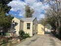 Home exterior shows driveway and backyard with trees, landscaping and sunshine at 1120 Dayton St, Aurora, CO 80010