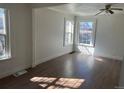 Sunny living room with large windows allowing ample natural light and beautiful hardwood floors at 1120 Dayton St, Aurora, CO 80010