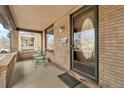 Inviting front porch featuring brick accents, outdoor seating, and a welcoming entrance with a decorative door at 377 S Grant St, Denver, CO 80209