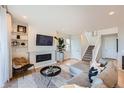 Comfortable living room featuring a fireplace, hardwood floors, and staircase to the upper level at 3625 Silver Rock Cir, Castle Rock, CO 80104