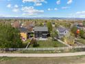Aerial view of a home with a fenced backyard in a residential neighborhood, showcasing the surrounding community at 5249 Mt Arapaho Cir, Frederick, CO 80504