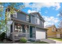 Beautiful two-story home featuring a covered porch with decorative details at 5249 Mt Arapaho Cir, Frederick, CO 80504