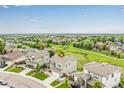 Aerial view of the property showcasing its location within a neighborhood and nearby golf course at 6990 E 132Nd Pl, Thornton, CO 80602