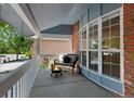 Cozy covered porch with outdoor seating and a decorative fire pit for relaxing evenings at 7773 Gunsight Pass, Littleton, CO 80127