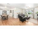Bright living room with hardwood floors, a ceiling fan, and a large window with natural light at 3865 Independence Ct, Wheat Ridge, CO 80033