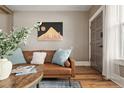 Cozy living room with a comfortable leather sofa and decorative wall art at 3725 Federal Blvd, Denver, CO 80211