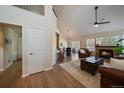 Warm and inviting living room featuring a cozy fireplace, vaulted ceilings, and an open layout at 10441 W Remington Dr, Littleton, CO 80127