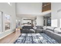 Bright living room featuring hardwood floors, a large sectional sofa, and open layout at 22678 E Lake Pl, Centennial, CO 80015