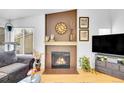 Bright living room with fireplace, hardwood floors, and stylish decor at 4856 S Quintero Cir, Aurora, CO 80015