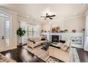 Bright living room with a cozy fireplace, built-in shelving, and stylish decor at 9182 Ridgegate Pkwy, Lone Tree, CO 80124