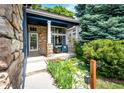 Inviting front porch with stone accents, comfortable seating, and a well-manicured garden enhancing the curb appeal at 1941 Fox Fire St, Highlands Ranch, CO 80129