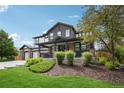 Attractive two-story home with a welcoming covered porch and lush landscaping at 21434 E Greenwood Pl, Aurora, CO 80013
