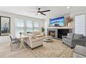 Bright living room featuring a cozy fireplace, large windows, and elegant decor at 21434 E Greenwood Pl, Aurora, CO 80013