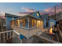 Charming blue home featuring a welcoming porch, a cozy fire pit area, and comfortable outdoor seating at 2041 Virginia St, Idaho Springs, CO 80452