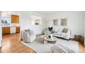 Cozy living room with hardwood floors, neutral decor, and open kitchen view at 235 Summit Cir, Lafayette, CO 80026