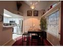 Charming dining area with adjacent kitchen featuring stainless steel appliances and modern finishes at 4933 S Carson St # 212, Aurora, CO 80015