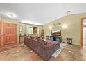 Comfortable living room featuring stone floors, a large sectional sofa, and natural light at 26499 West St, Conifer, CO 80433