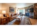 Comfortable living room featuring a stone fireplace, plush seating, and warm lighting at 765 Columbine St # C203, Breckenridge, CO 80424