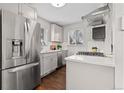 Updated kitchen with stainless steel appliances, white subway tile backsplash and hardwood floors at 2950 Hudson St, Denver, CO 80207