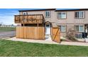Townhome exterior showing a wood fence and a covered balcony at 7700 W Glasgow Pl # 11C, Littleton, CO 80128