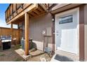 Exterior front door showing adjacent wooden fence and a gas grill at 7700 W Glasgow Pl # 11C, Littleton, CO 80128