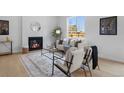 Cozy living area with fireplace, stylish decor, and natural light from a window at 4002 Upham St, Wheat Ridge, CO 80033