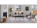 Bright living room with modern decor, a fireplace, and a large window at 4002 Upham St, Wheat Ridge, CO 80033
