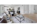 Open-concept living area featuring a dining table and modern furnishings at 4002 Upham St, Wheat Ridge, CO 80033