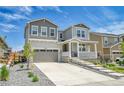 Inviting two-story home with a charming front porch, beautiful stone accents, and a well-manicured lawn at 3888 Grand Baker St, Aurora, CO 80019