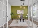 Bright office featuring a glass desk, modern lighting, and neutral decor, creating a productive workspace at 14066 Ivanhoe Ct, Thornton, CO 80602