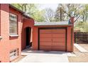 Attached garage featuring brick exterior, with archway, and door at 650 Kearney St, Denver, CO 80220