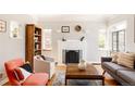 Bright living room with hardwood floors, a cozy fireplace, and large windows for natural light at 650 Kearney St, Denver, CO 80220