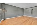 Open living room featuring hardwood floors and modern light fixture at 3818 W 25Th Ave, Denver, CO 80211