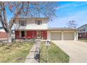 Charming two-story home with a brick facade, landscaped yard, and a spacious two-car garage at 1941 E 119Th Pl, Northglenn, CO 80233