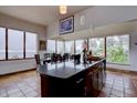 Kitchen island with dining table and chairs in a room with large windows and scenic views at 1150 Madge Gulch Rd, Sedalia, CO 80135