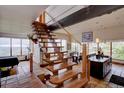 Open staircase leading to a dining area with floor to ceiling windows and a view at 1150 Madge Gulch Rd, Sedalia, CO 80135