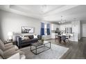 Open-concept living area with modern furnishings, seamlessly connecting the living room and kitchen at 10786 Bear Cub Dr, Broomfield, CO 80021