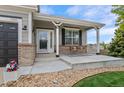 Inviting front porch features a swing and decorative accents at 688 Cinnabar Ln, Castle Rock, CO 80108