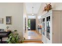 Welcoming entryway with hardwood floors, a stylish pendant light, and neutral decor at 85 Willowleaf Dr, Littleton, CO 80127