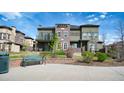 Attractive townhouse with landscaped front yard and inviting bench seating at 924 Brookhurst Ave # C, Highlands Ranch, CO 80129