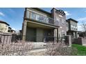 Comfortable covered front porch with seating and iron railing at 924 Brookhurst Ave # C, Highlands Ranch, CO 80129