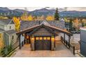 Spacious garage featuring a carriage door, covered parking, mountain views, and exterior lighting at 224 S Ridge St, Breckenridge, CO 80424