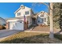 This two-story home with a brick-accented garage boasts curb appeal with tidy landscaping at 7641 Lebrun Ct, Lone Tree, CO 80124