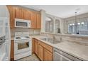 Bright kitchen features wood cabinets and stainless steel appliances at 1354 Carlyle Park Cir, Highlands Ranch, CO 80129