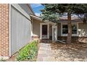 Close-up of the front door with stone walkway, colorful flowers and rock features add curb appeal at 4650 S Laredo St, Aurora, CO 80015