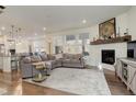 Spacious living room with corner fireplace and large windows at 19011 W 84Th Ave, Arvada, CO 80007