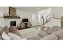 Open living room featuring a fireplace and hardwood floors at 19011 W 84Th Ave, Arvada, CO 80007