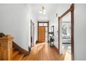 Inviting entryway with hardwood floors, wooden staircase, and natural light at 2823 N Lafayette St, Denver, CO 80205